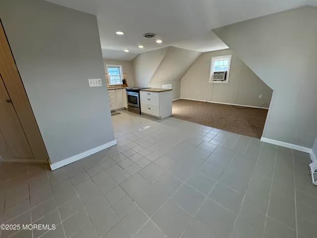 a view of a kitchen with a sink and a refrigerator