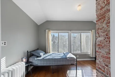 a bed sitting in a bedroom next to a window