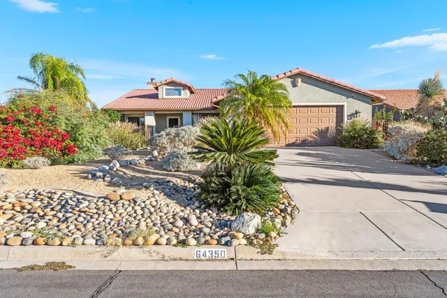 a front view of a house with a yard and a garage