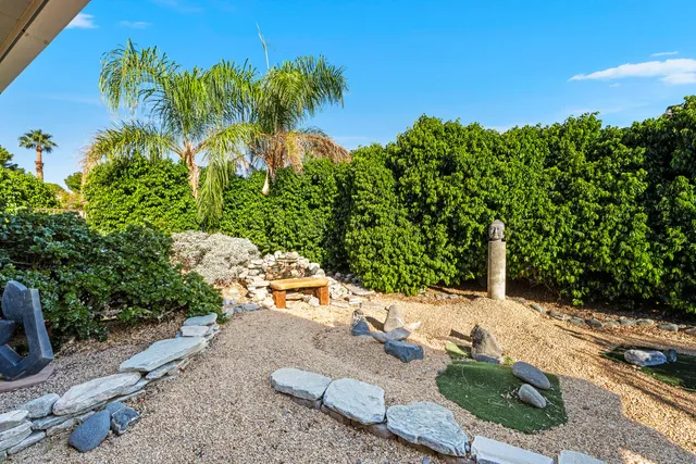 a view of a backyard with plants and a patio