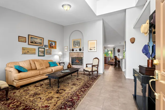 a living room with furniture a rug and a window