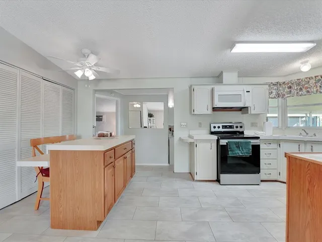 a kitchen with stainless steel appliances a stove a sink and a refrigerator