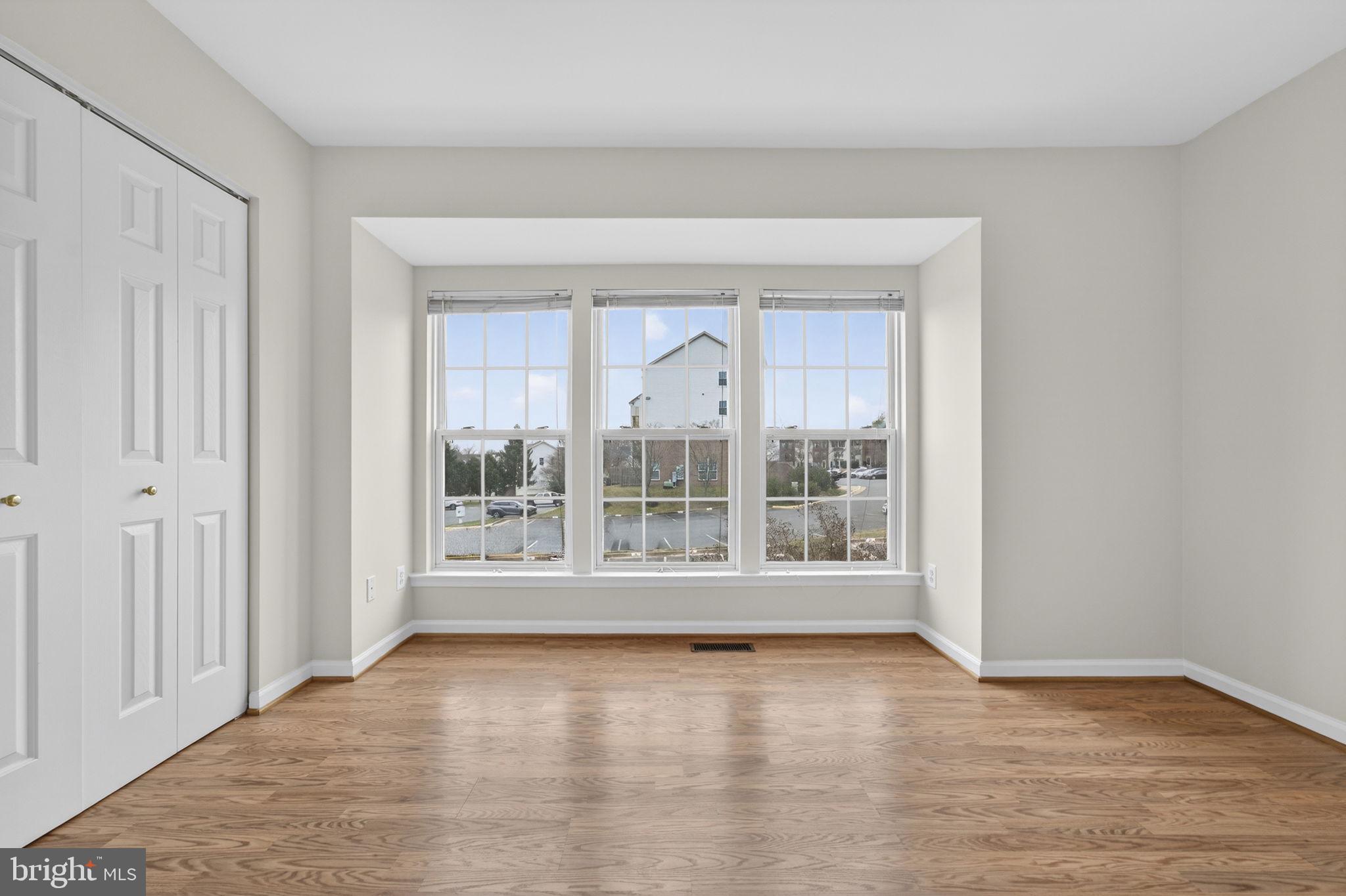 6741 Stone Maple Terrace Centreville, VA 20121 - Photo 14 of 24 wooden floor in an empty room with a window