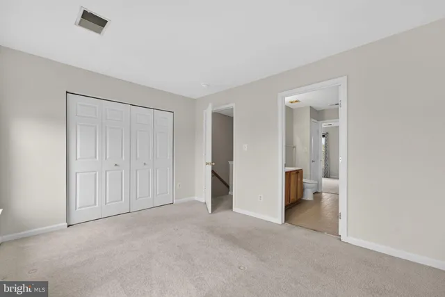 an empty room with a bathroom and a sink