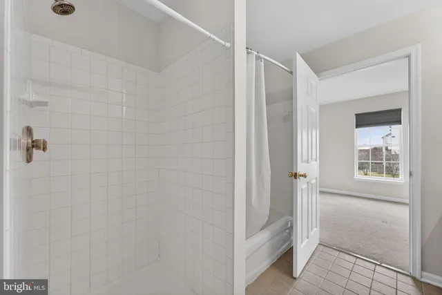a bathroom with a shower and a glass door