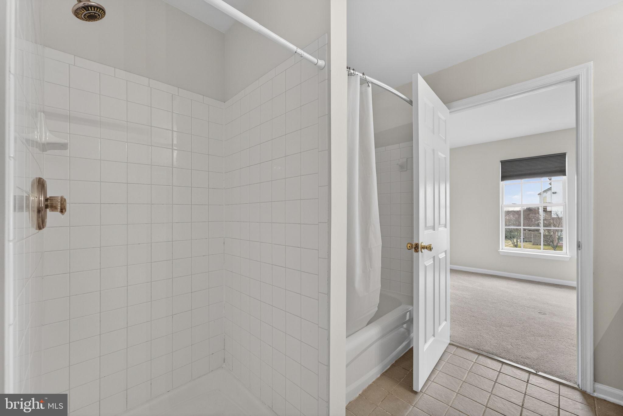 6741 Stone Maple Terrace Centreville, VA 20121 - Photo 20 of 24 a bathroom with a shower and a glass door
