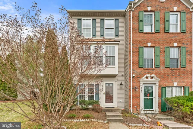 front view of a brick house with a large windows