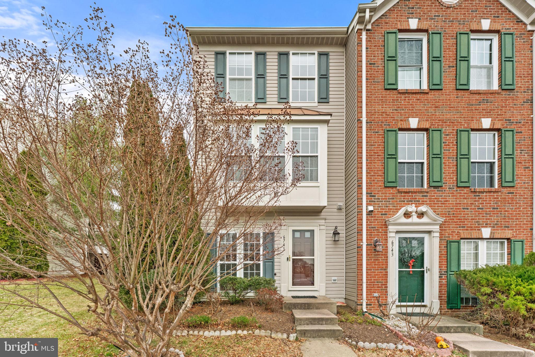 6741 Stone Maple Terrace Centreville, VA 20121 - Photo 24 of 24 front view of a brick house with a large windows