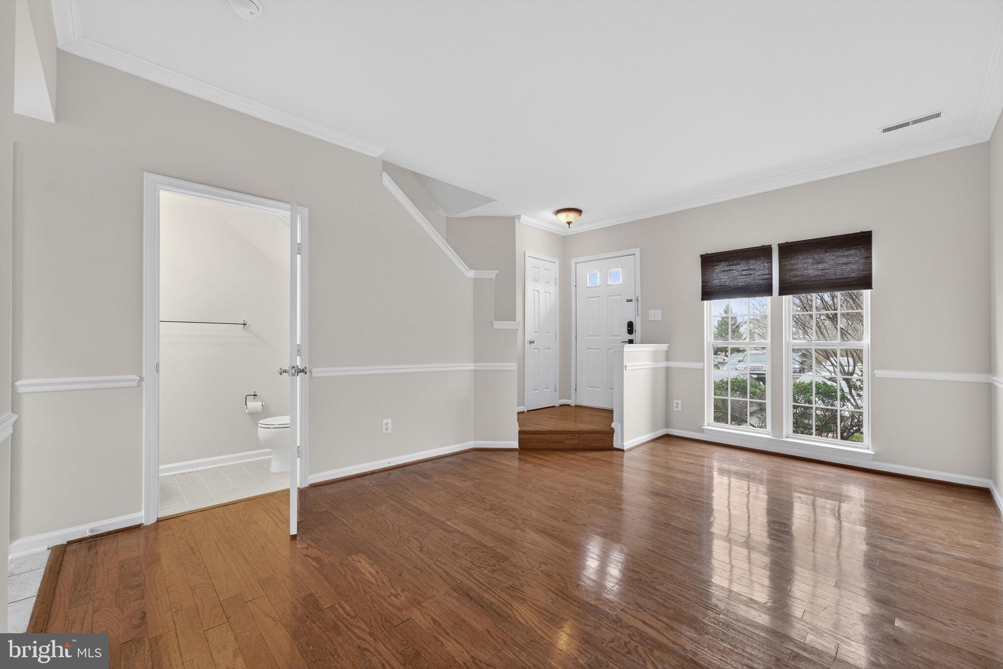 6741 Stone Maple Terrace Centreville, VA 20121 - Photo 4 of 24 an empty room with wooden floor and windows