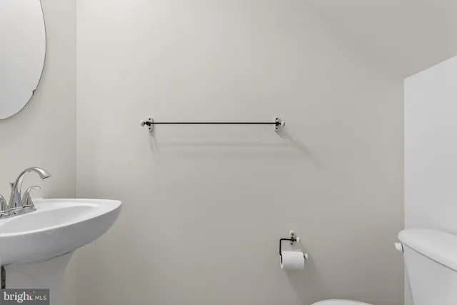 a bathroom with a sink a toilet and mirror