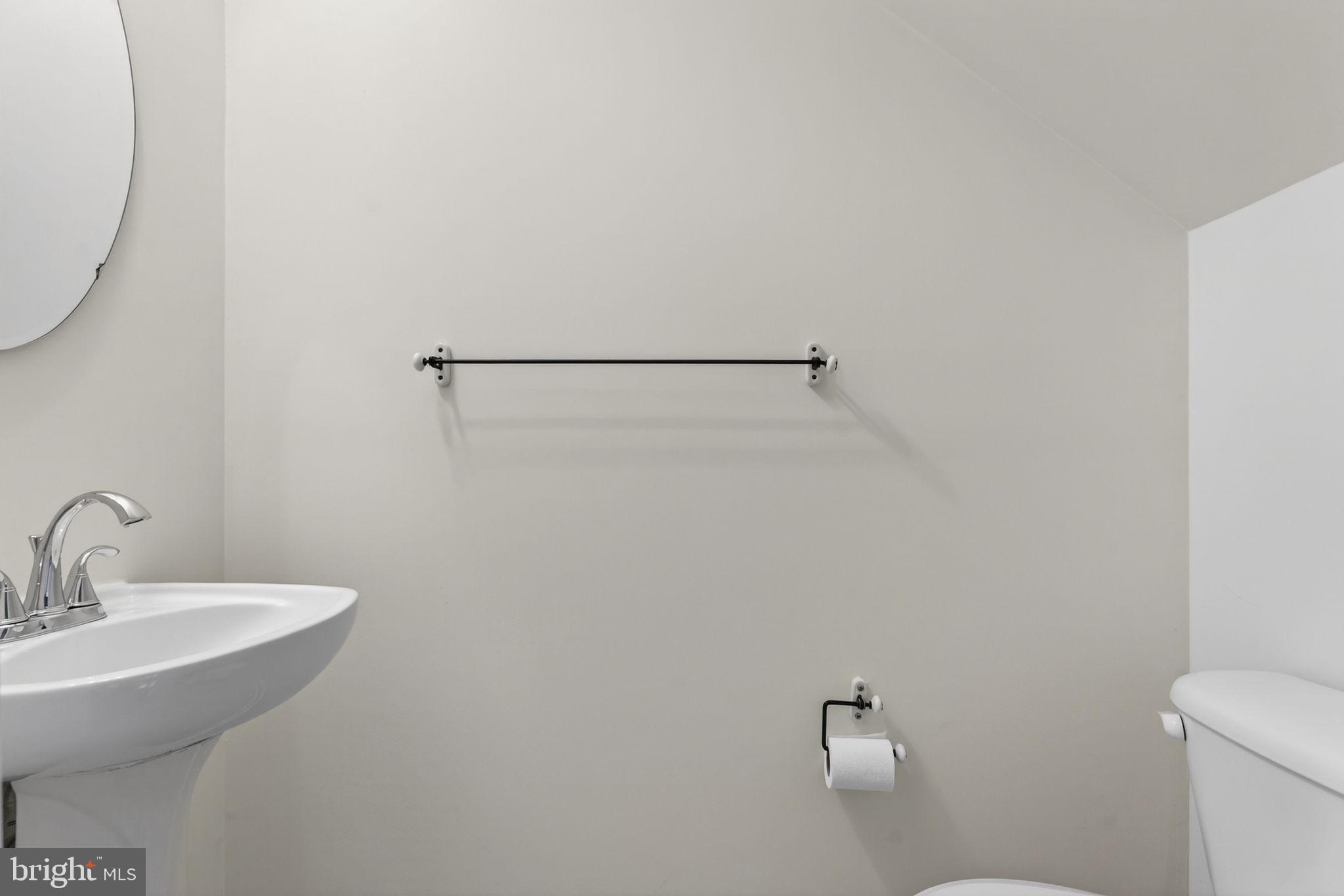 6741 Stone Maple Terrace Centreville, VA 20121 - Photo 5 of 24 a bathroom with a sink a toilet and mirror