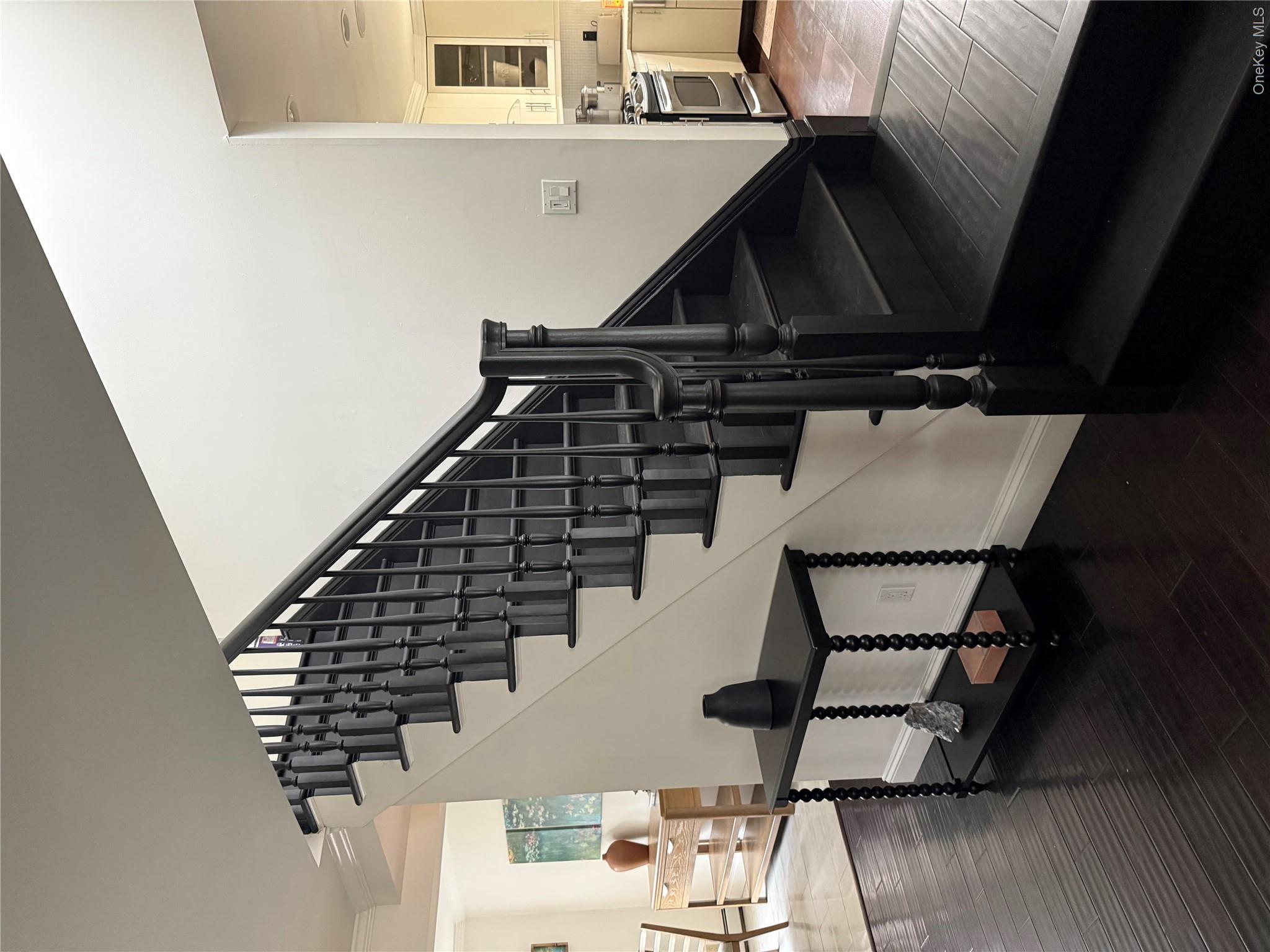 29 Wilton Road Rye Brook, NY 10573 - Photo 9 of 18 Stairs featuring crown molding, wood finished floors, and baseboards