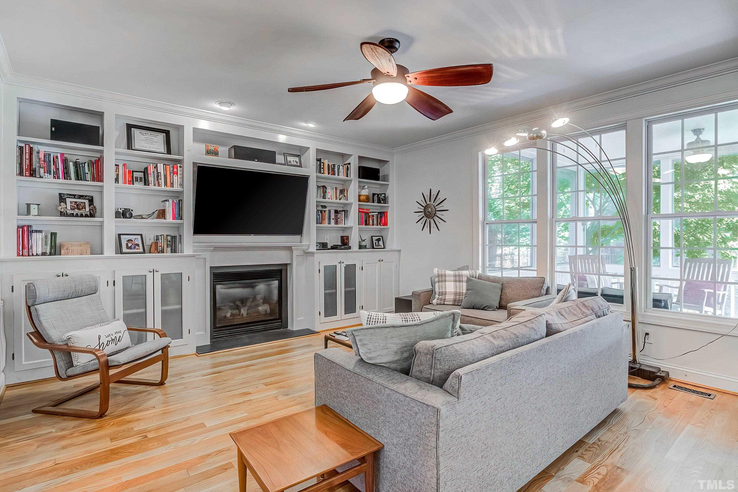 1613 Strategy Way Wake Forest, NC 27587 - Photo 11 of 58 a living room with furniture a fireplace and a flat screen tv