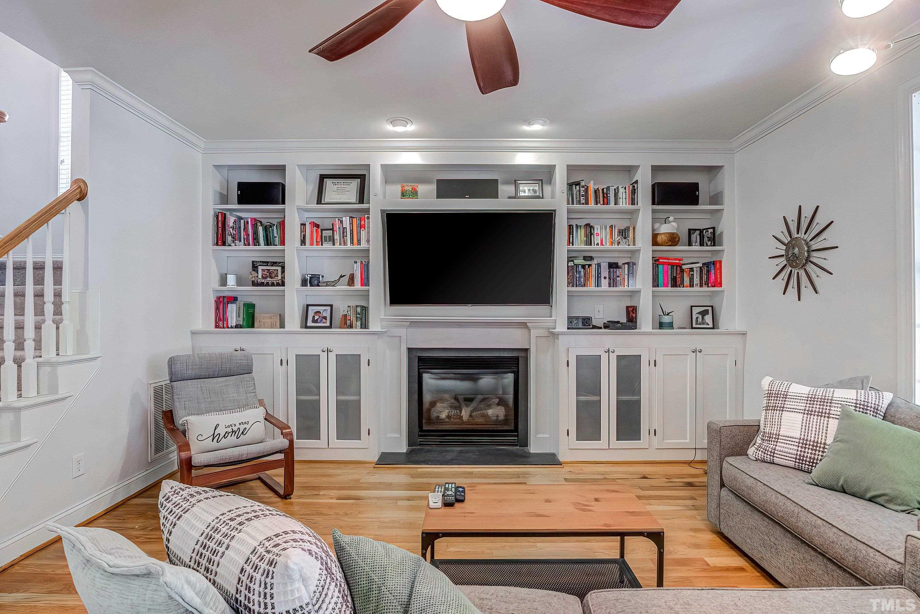 1613 Strategy Way Wake Forest, NC 27587 - Photo 12 of 58 a living room with furniture a flat screen tv and a fireplace