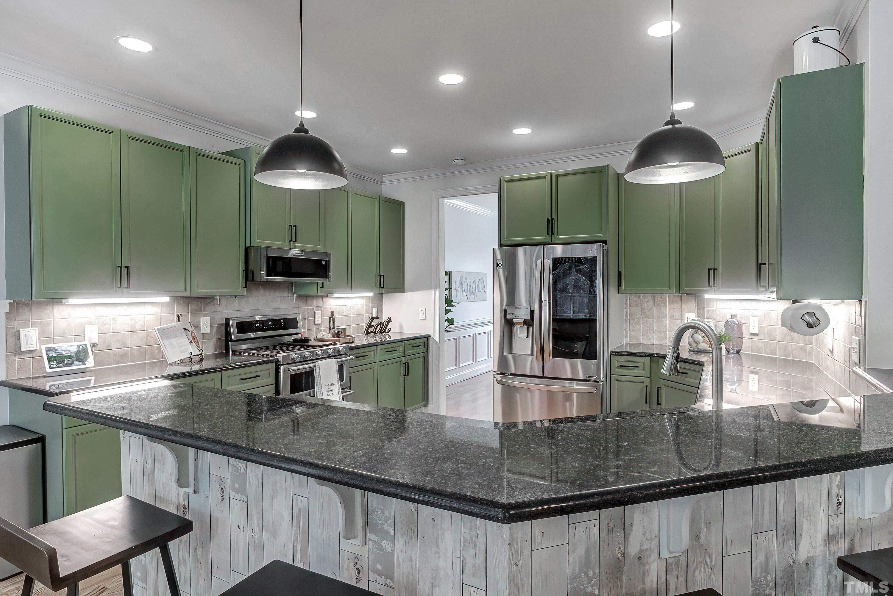 1613 Strategy Way Wake Forest, NC 27587 - Photo 20 of 58 a kitchen with kitchen island a counter space cabinets and appliances