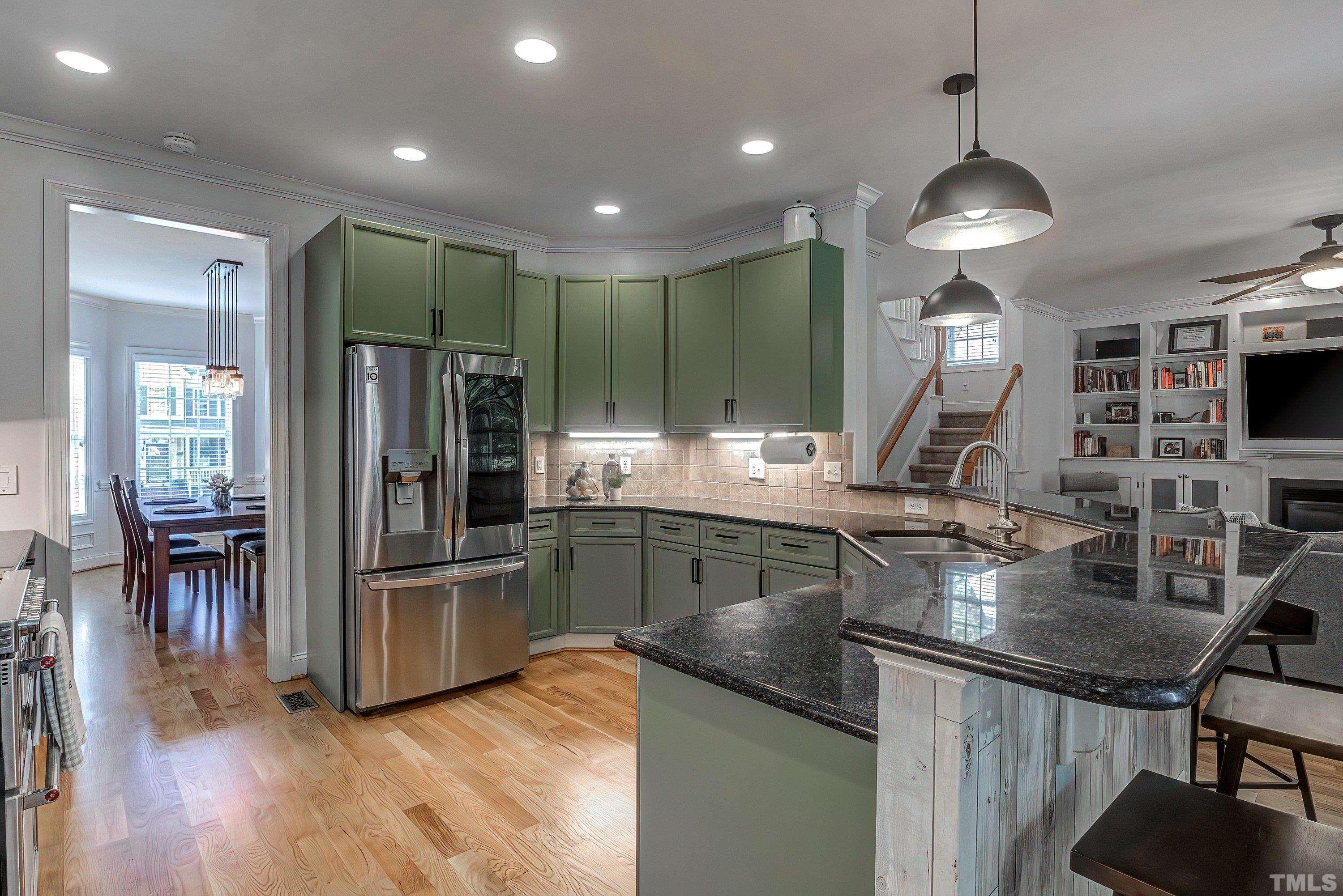 1613 Strategy Way Wake Forest, NC 27587 - Photo 22 of 58 a kitchen with stainless steel appliances granite countertop a sink refrigerator and cabinets
