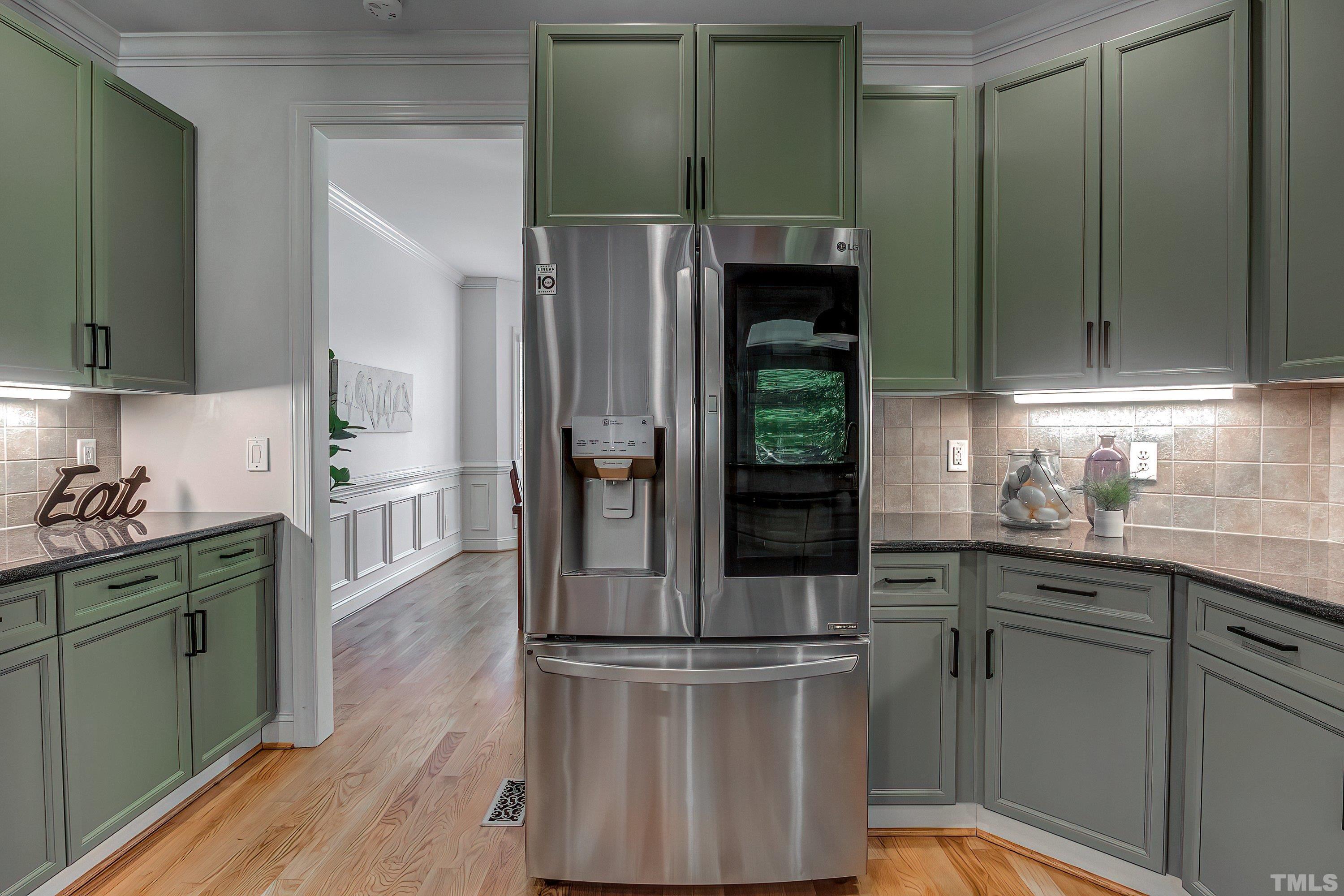 1613 Strategy Way Wake Forest, NC 27587 - Photo 23 of 58 a kitchen with kitchen island granite countertop a refrigerator and a sink