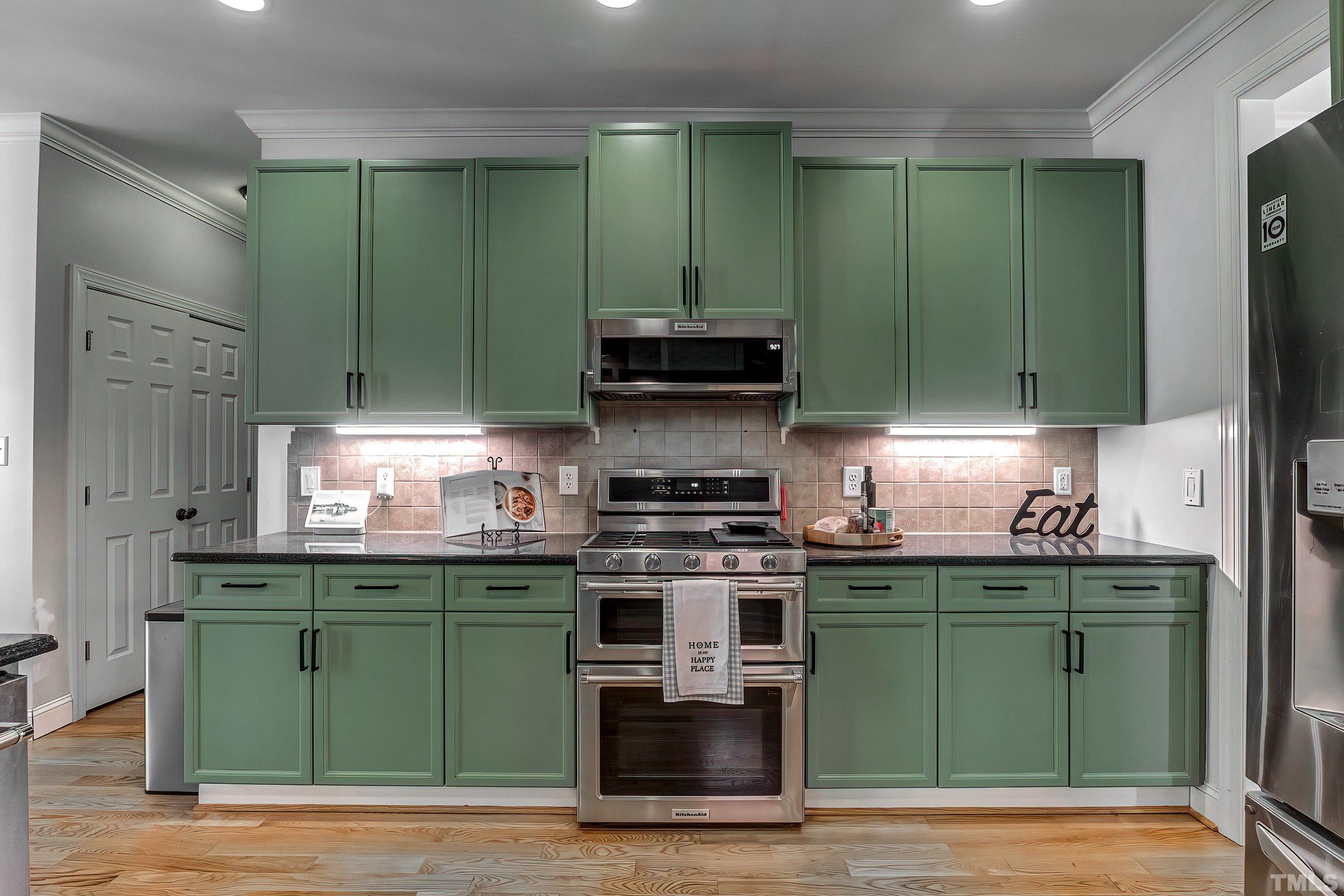 1613 Strategy Way Wake Forest, NC 27587 - Photo 24 of 58 a kitchen with a sink a stove and cabinets