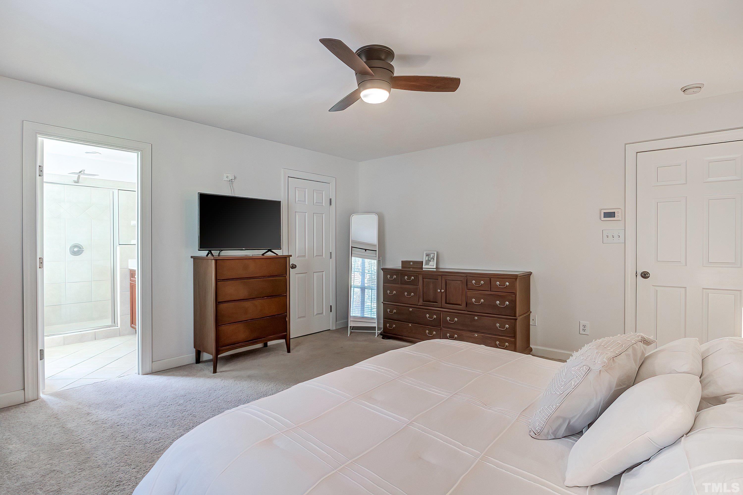 1613 Strategy Way Wake Forest, NC 27587 - Photo 29 of 58 a bedroom with a bed and a television