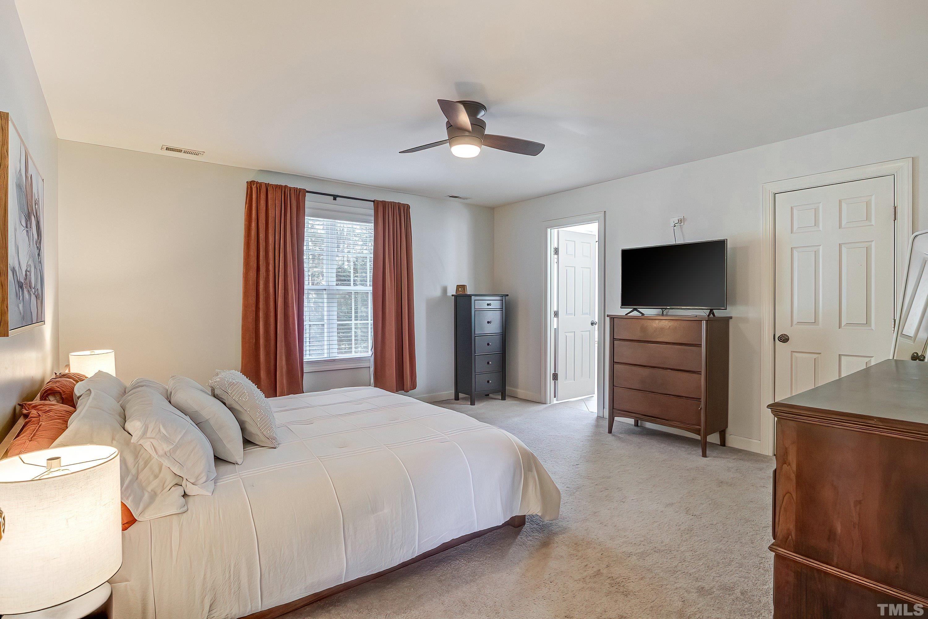 1613 Strategy Way Wake Forest, NC 27587 - Photo 30 of 58 a bedroom with a bed and a television