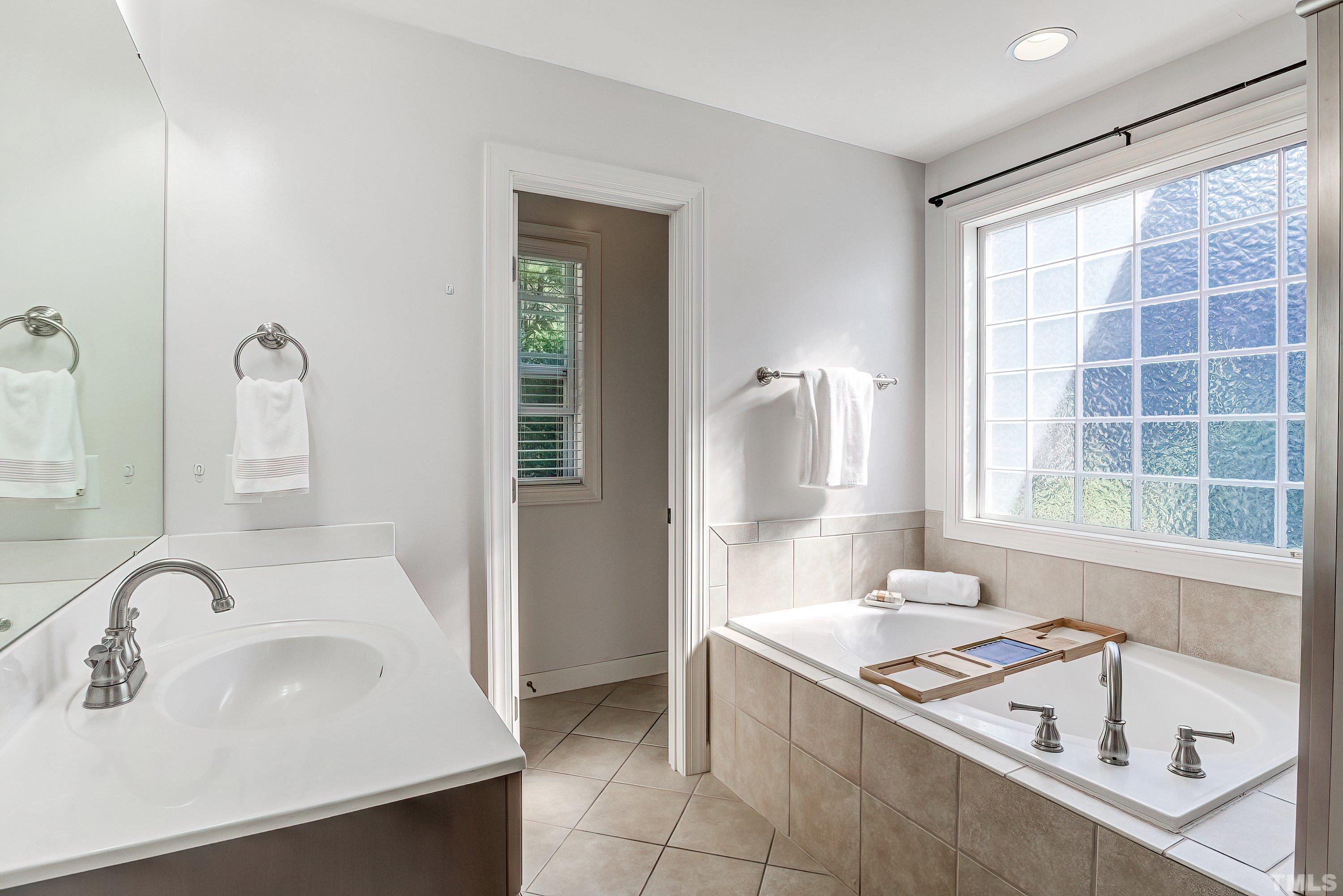 1613 Strategy Way Wake Forest, NC 27587 - Photo 33 of 58 a bathroom with a sink and a bathtub