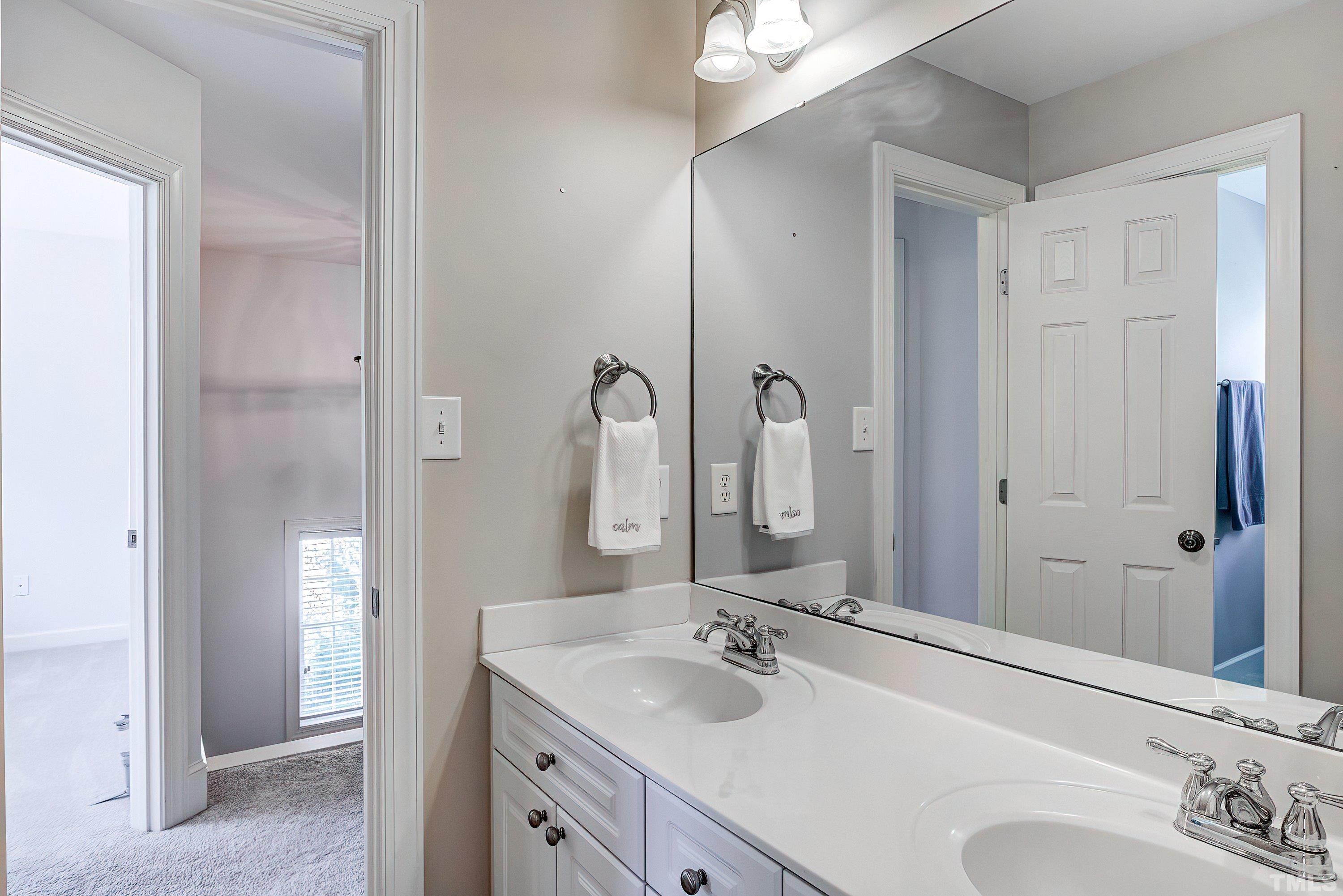 1613 Strategy Way Wake Forest, NC 27587 - Photo 35 of 58 a bathroom with a sink and a mirror