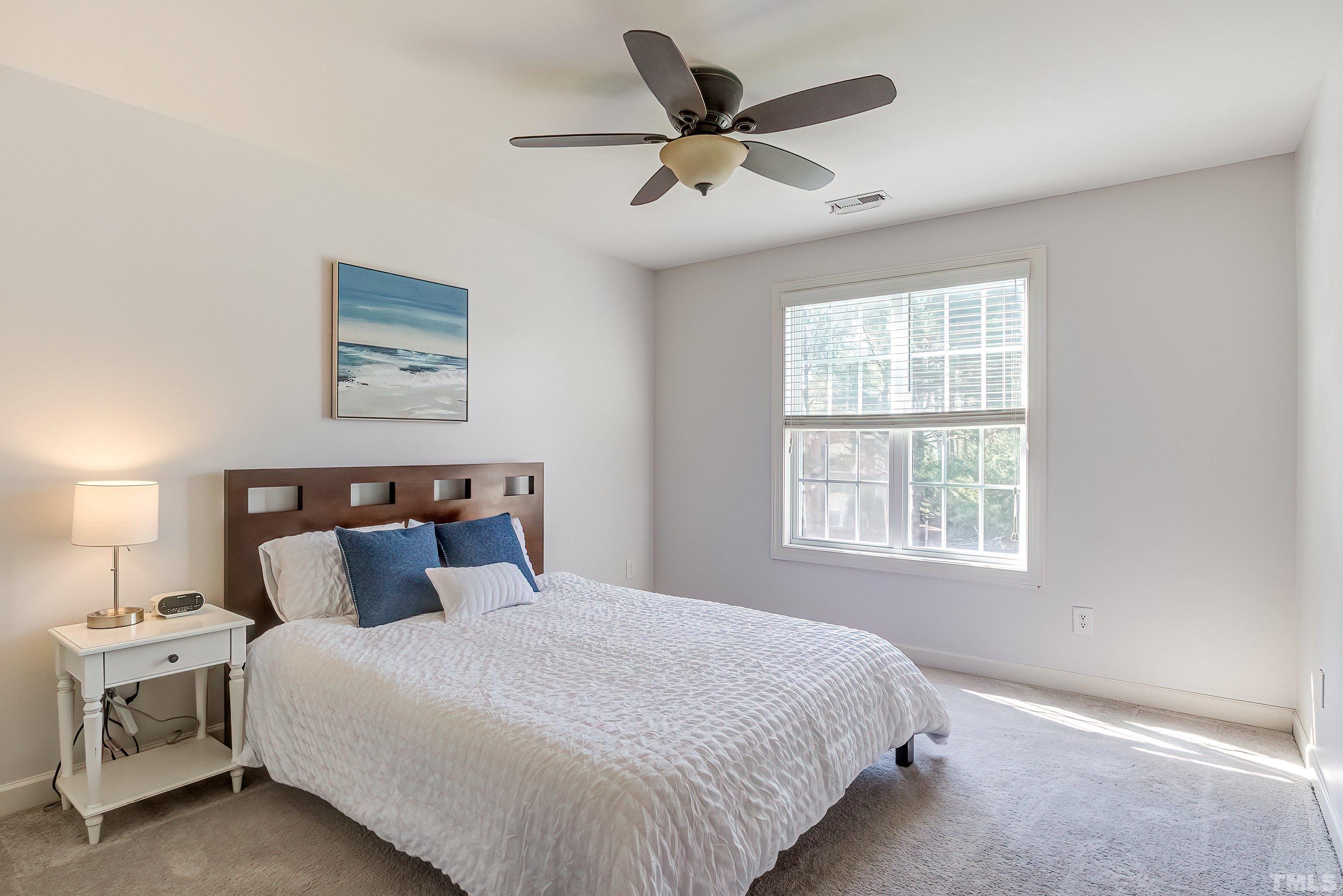 1613 Strategy Way Wake Forest, NC 27587 - Photo 38 of 58 a bedroom with a bed and a window