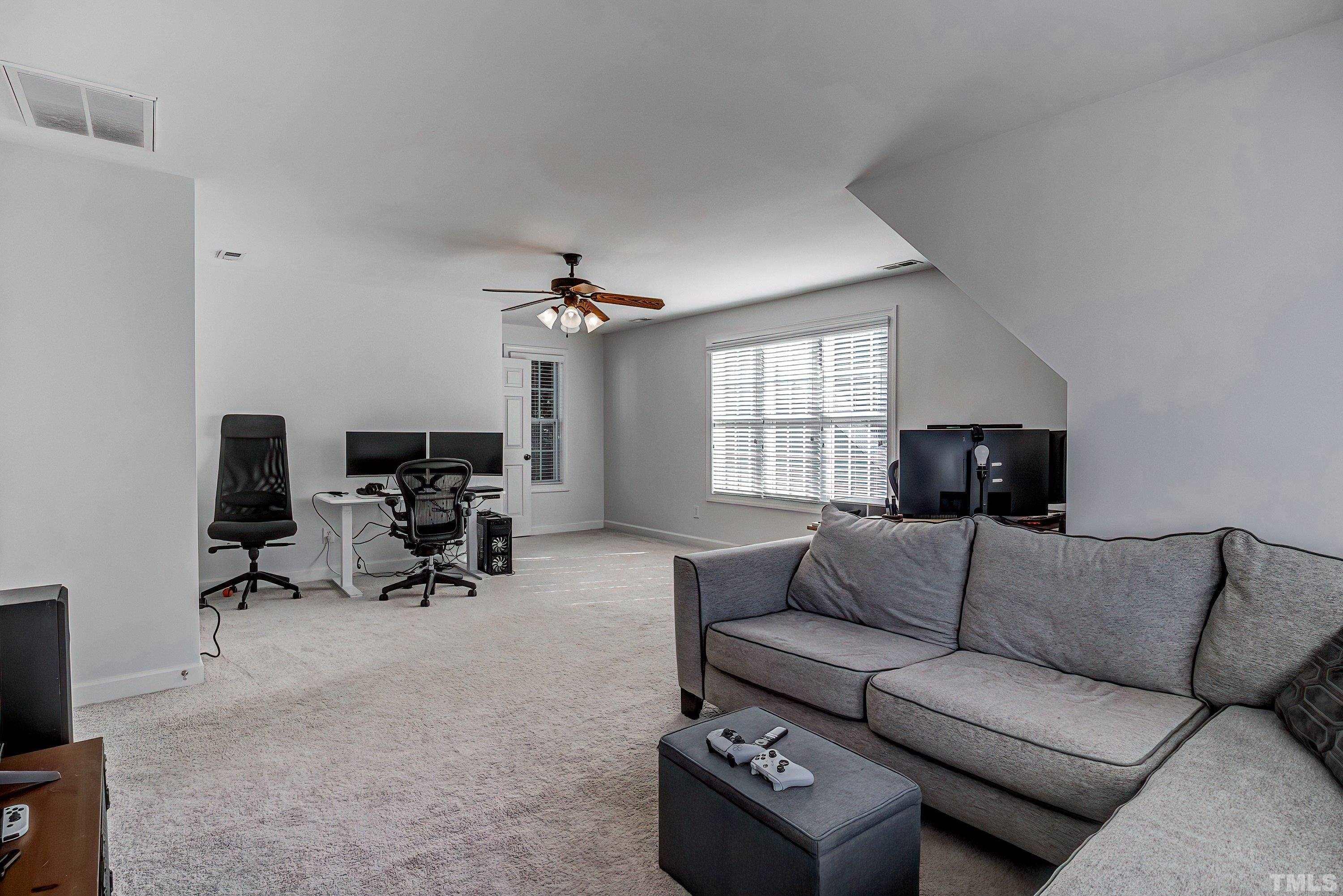 1613 Strategy Way Wake Forest, NC 27587 - Photo 41 of 58 a living room with furniture and a flat screen tv