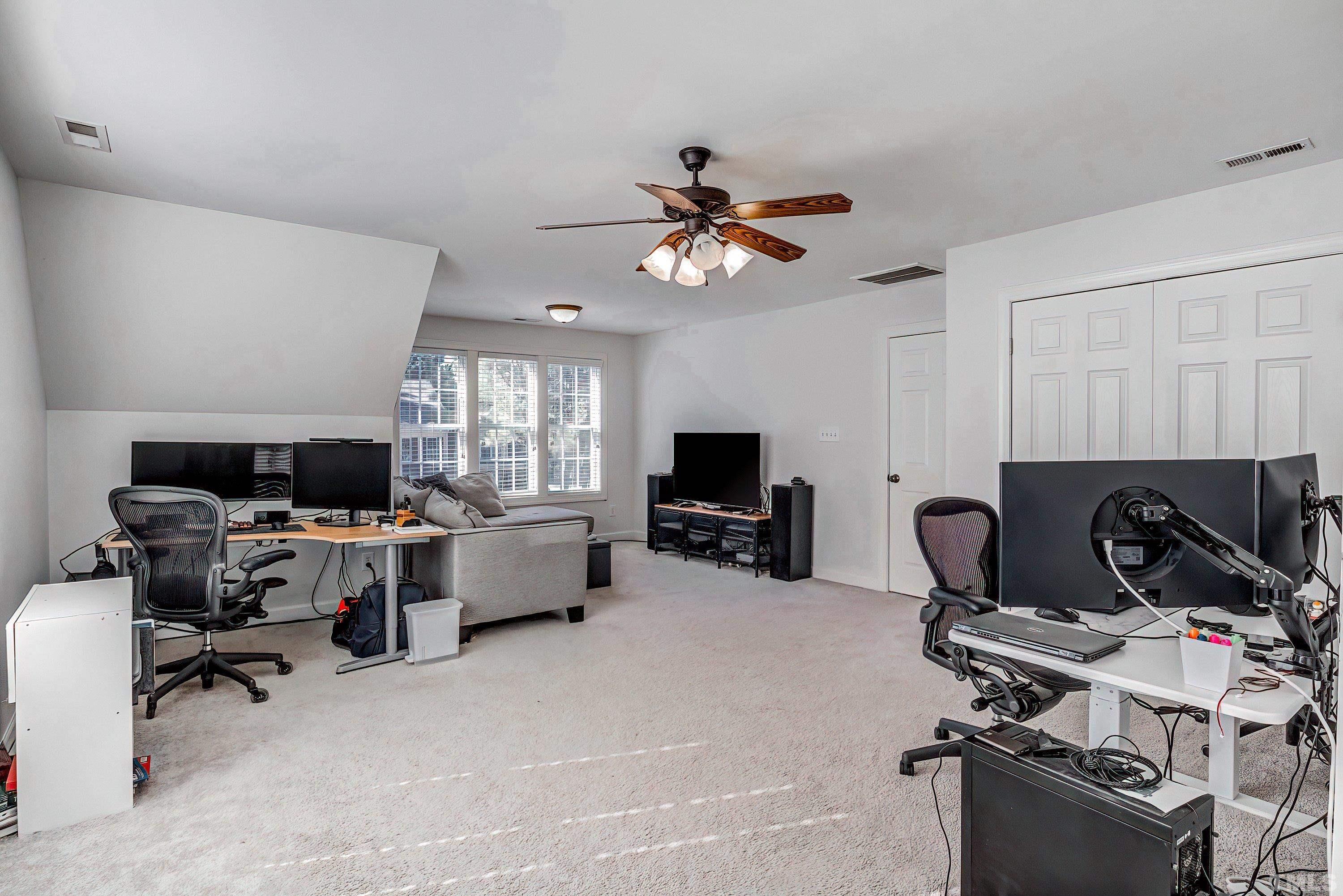 1613 Strategy Way Wake Forest, NC 27587 - Photo 42 of 58 a view of a workspace with furniture and a flat screen tv