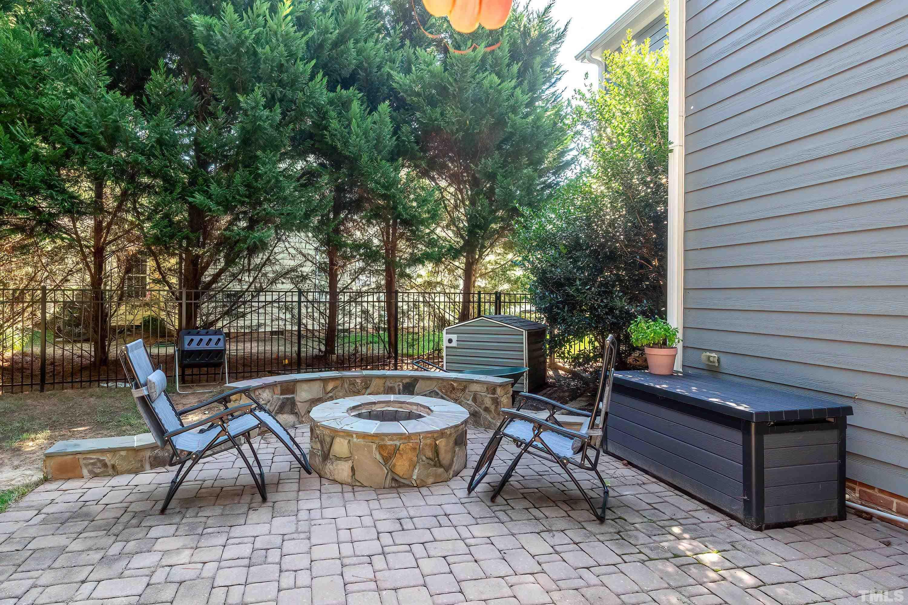 1613 Strategy Way Wake Forest, NC 27587 - Photo 48 of 58 a view of a patio with table and chairs and potted plants