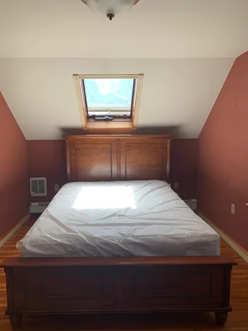 a bedroom with a bed and window