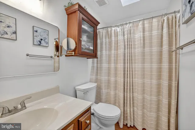 a white toilet sitting next to a bathroom sink