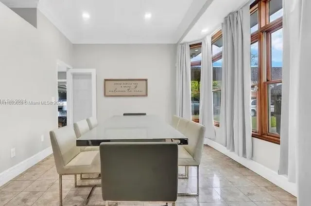 a room with a table chairs and entryway