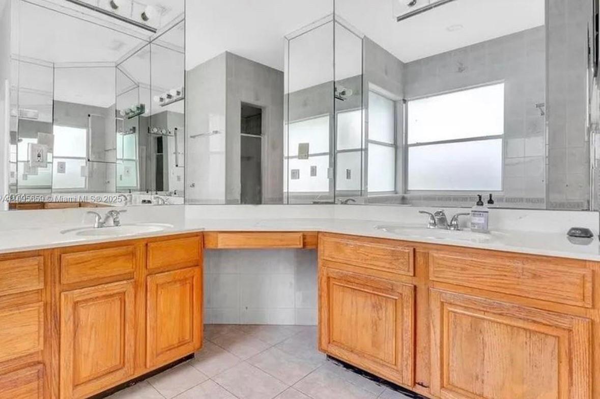 19905 Southwest 135th Avenue Miami, FL 33177 - Photo 15 of 34 a bathroom with a sink double vanity and a large mirror