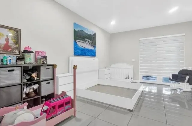 a spacious bedroom with a bed and a shelf