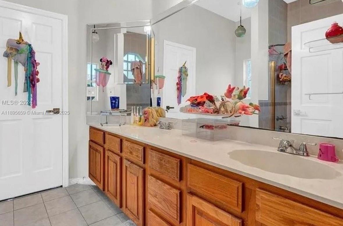 19905 Southwest 135th Avenue Miami, FL 33177 - Photo 21 of 34 a bathroom with a sink vanity and a mirror