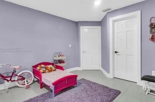 a bedroom with furniture and a rug