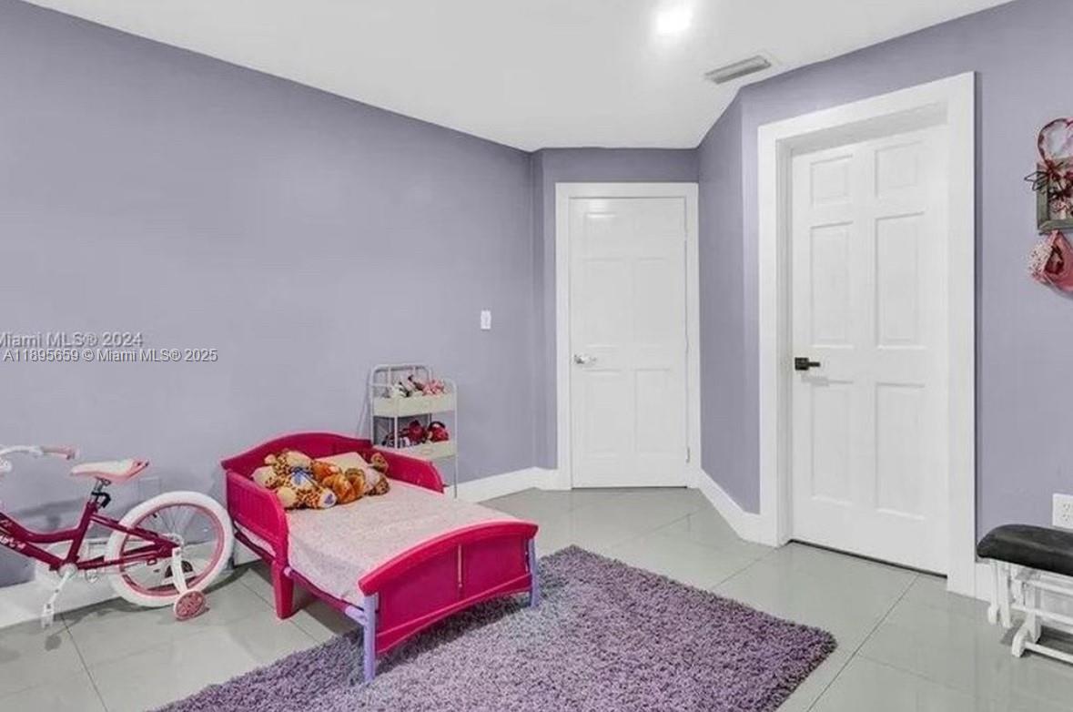 19905 Southwest 135th Avenue Miami, FL 33177 - Photo 23 of 34 a bedroom with furniture and a rug