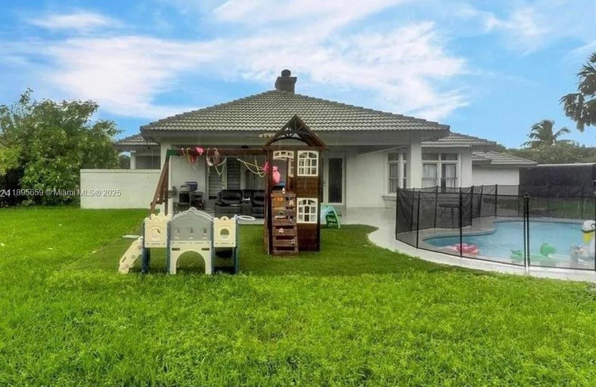 19905 Southwest 135th Avenue Miami, FL 33177 - Photo 33 of 34 a view of a house with a yard