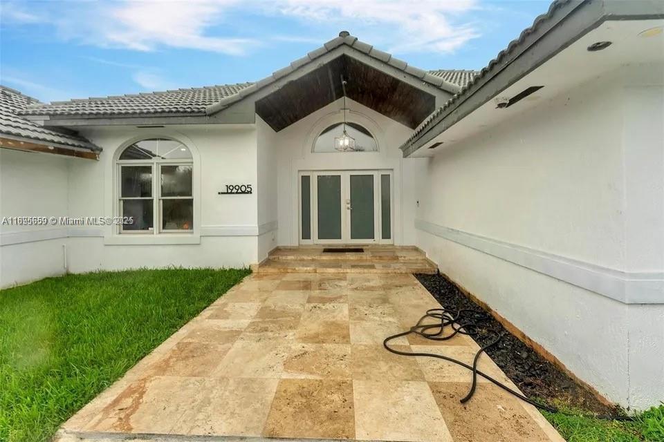 19905 Southwest 135th Avenue Miami, FL 33177 - Photo 5 of 34 front view of a house with a yard