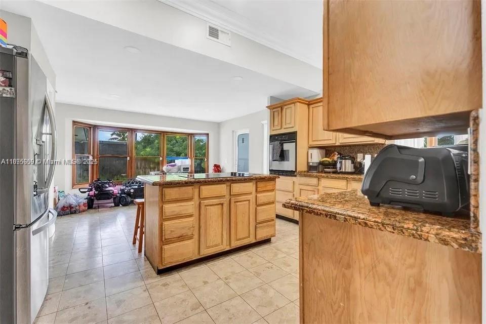 19905 Southwest 135th Avenue Miami, FL 33177 - Photo 7 of 34 a kitchen with stainless steel appliances granite countertop a sink and a refrigerator