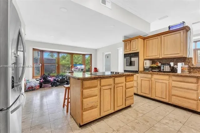 a kitchen with sink cabinets and living room