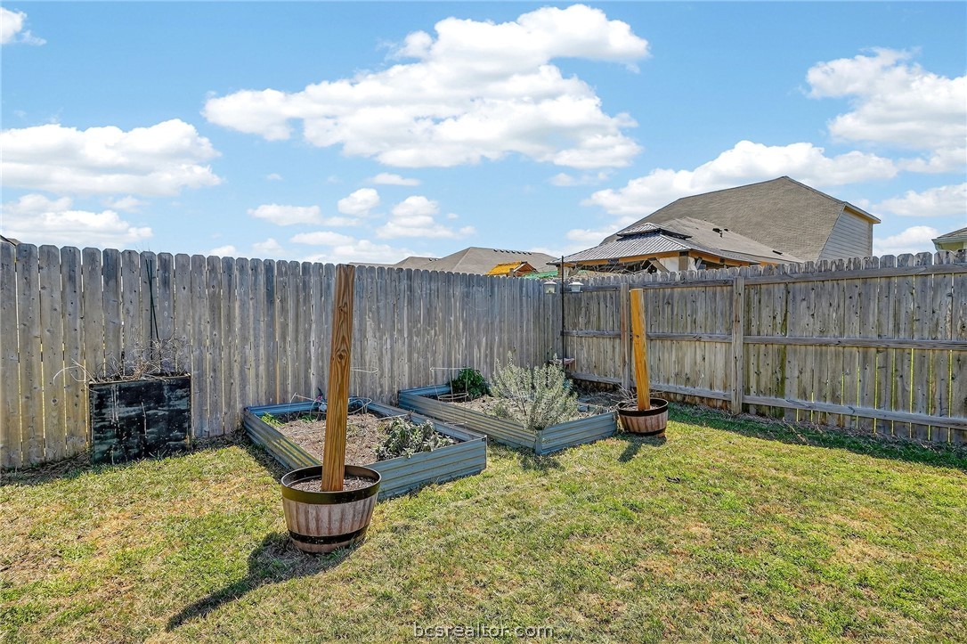 5235 Montague Loop Bryan, TX 77807 - Photo 23 of 25 a backyard of a house with fountain table and chairs