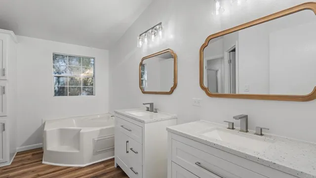 a bathroom with 2 sink and a mirror