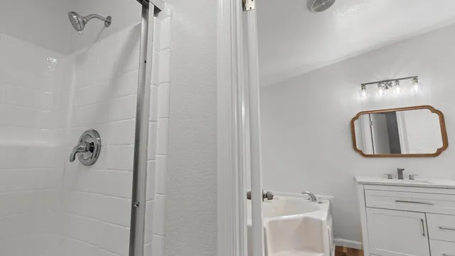 a bathroom with a sink vanity and mirror