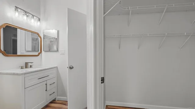 a bathroom with a sink vanity and mirror