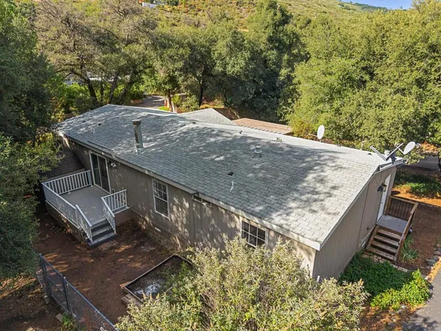 a view of a backyard with a tree