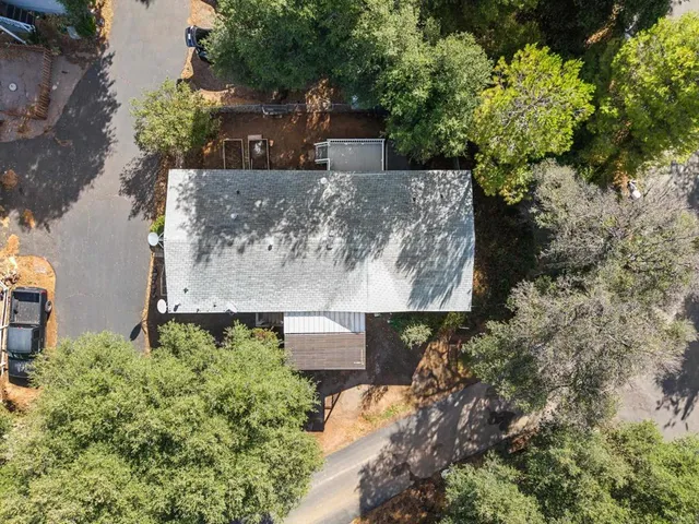 an aerial view of a house with a yard