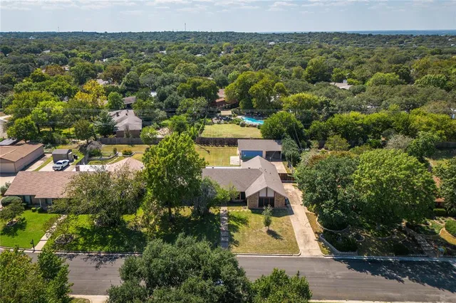 an aerial view of a house with a yard