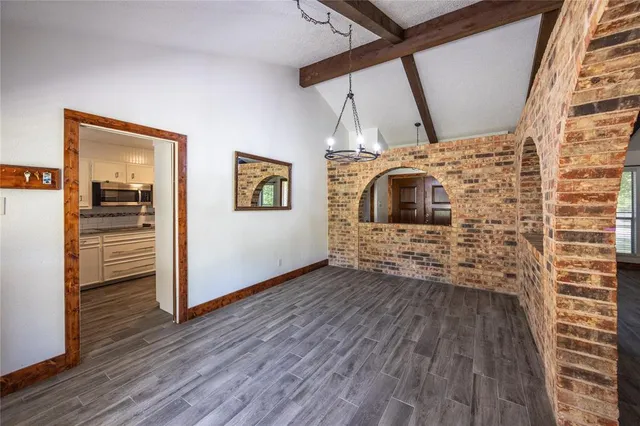 a view of a livingroom with wooden floor and a ceiling fan